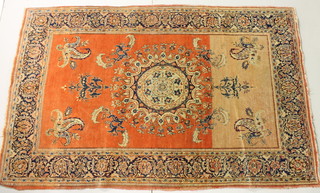 A peach ground Persian rug with central medallion 83" x 52 1/2" 