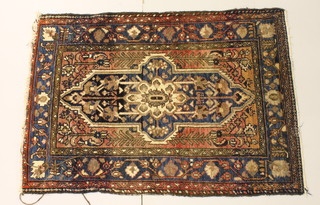 A blue and red ground Afghan rug with central medallion 53 1/2" x 37" 
