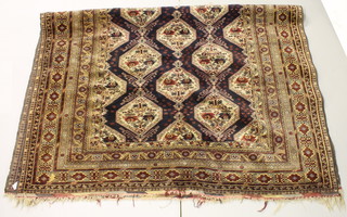 A Belouch rug with stylised octagons to the centre 105" x 77" 