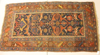 A Persian rug with stylised animals to the centre 84" x 47" 