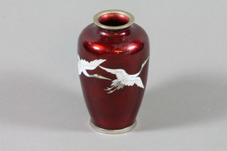 A late 19th Century cloisonne overform vase, the red ground with flying heron, 5" ILLUSTRATED 