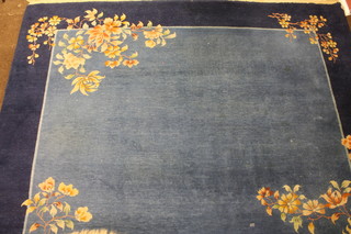 A 1930's Chinese blue ground and floral patterned carpet, some wear, 143" x 109"