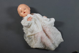 A 1940's Evergreen plastic baby doll, with closing eyes and open mouth with moving tongue