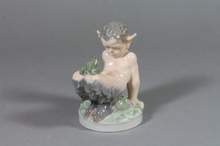 A Royal Copenhagen figure of Pan with a frog sitting on his knees 4"