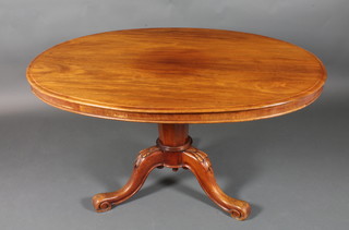 A Victorian oval mahogany snap top supper table raised on a chamfered column and tripod base 31" x 53" x 39"