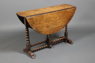 An oak gateleg dining table, raised on bobbin legs 28" x 42" x 42"