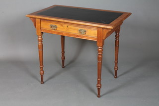James Shoolbred & Co, a walnut writing table, the top with  tooled black leather skiver above a frieze drawer, raised on ring  turned tapered legs, peg feet 30"h x 36"h x 22"d