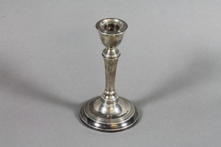 A silver tapered dwarf candlestick