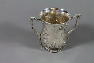 A mid Victorian repousse silver 2 handled cup decorated with vineous decoration, London 1833