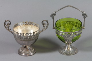 An Art Nouveau pierced WMF dish with swing handle and green glass liner together with a twin handled bowl raised on a spreading foot 