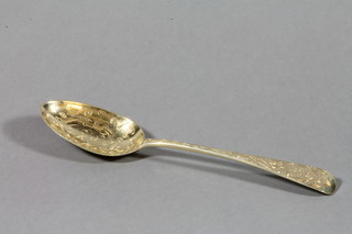 A Victorian silver gilt chased dessert spoon, London 1856