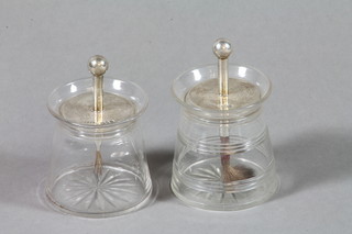 A pair of glass glue pots with silver mounts