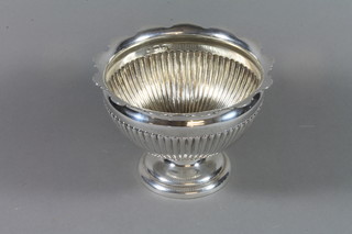 An Edwardian circular silver bowl with fluted body, raised on a circular spreading foot Birmingham 1907, maker Elkington & Co., 17 ozs 