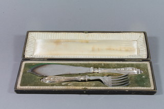 A pair of silver plated fish servers with bone handles, cased