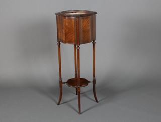 A serpentine mahogany jardiniere with metal liner, raised on tapered legs with undertier 40" x 31" x 21.5"