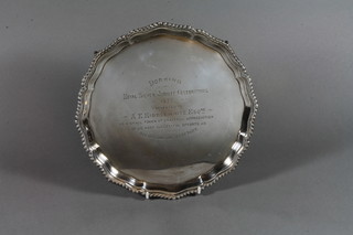 A silver salver with bracketed border raised on ball and claw feet, London 1930, maker Robert Pringle & Sons, 19 ozs ILLUSTRATED