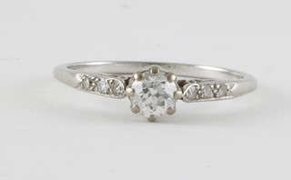 An 18ct white gold or platinum set dress ring, set a solitaire diamond