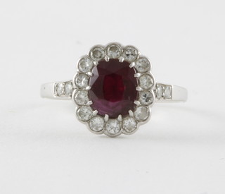 A lady's 18ct white gold and platinum dress ring set a ruby surrounded by diamonds