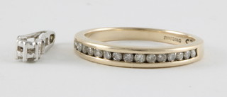 A lady's 9ct white gold half eternity ring set diamonds together with a diamond pendant