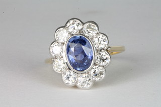 An 18ct white gold dress ring set an oval cut sapphire surrounded by diamonds, approx 1.55ct/1.25ct ILLUSTRATED