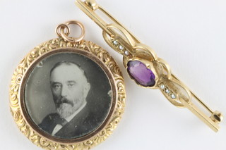 A 9ct gold bar brooch set an amethyst and a 9ct gold double photograph locket