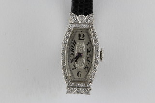 A lady's platinum cocktail wristwatch set diamonds on a leather strap