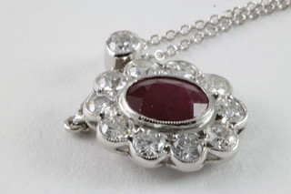 An 18ct white gold pendant set a ruby surrounded by diamonds, approx 1.05/1.55ct