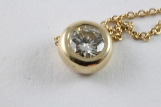 A gold pendant set a circular cut diamond, approx 0.51ct, hung on a fine gold chain