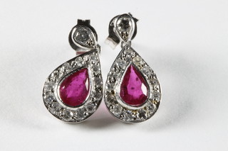 A pair of 18ct white gold tear drop earrings set rubies and diamonds approx 1.50/0.65ct
