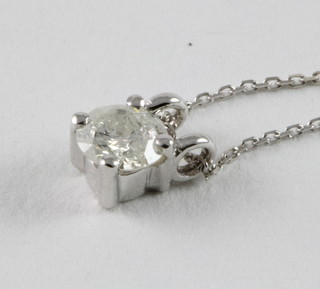 An 18ct gold pendant set a diamond, approx. 0.33ct, hung on an 18ct gold chain