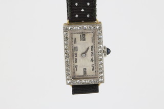 A lady's cocktail wristwatch contained in a rectangular 18ct gold case set diamonds