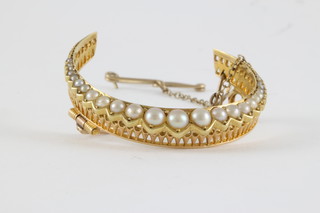 A gold crescent shaped brooch set demi-pearls