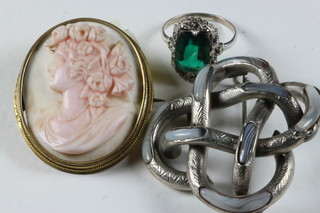 A shell carved cameo portrait brooch of a lady, a silver brooch in the form of a Celtic knot together with a silver dress ring set a blue stone