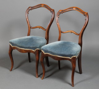 A pair of walnut carved dining chairs