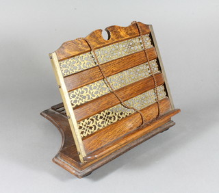 A Victorian oak and brass book rack 10"