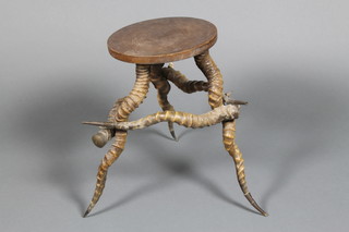 An oak topped stool with horn supports 17" x 10" 