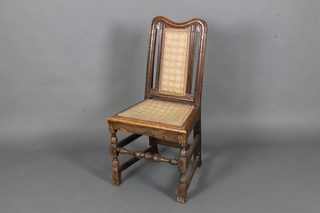 An 18th Century oak hall chair with embroidered seat and back  raised on turned and block supports