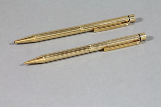 A Sheaffer ball point pen contained in a gold plated case together with a propelling pencil