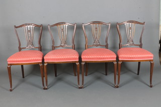A set of 4 Edwardian mahogany dining chairs with pierced rail  slat backs and upholstered seats raised on French cabriole  supports