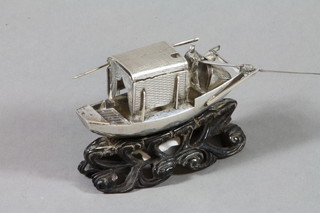 An Oriental silver mustard pot in the form of a boat 