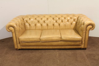 A 3 seat Chesterfield upholstered in cream buttoned back leather 29"h x 82"w x 35"d