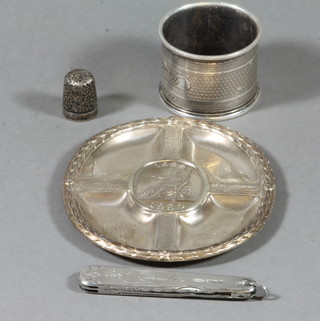 A silver ashtray to commemorate the 300th Anniversary of the Bank of England 3", a silver napkin ring and a silver thimble, 4 ozs together with a folding pen knife with silver mounts