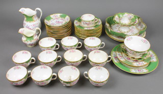A Mintons chinoiserie design tea set comprising 10 tea cups, 12 saucers, 11 small plates, 1 coffee cup, 1 coffee saucer and 1 tazza, milk jug, cream jug, sugar bowl, 3 large plates, 3 dishes and a shaped bowl