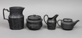 A black Basalt milk jug decorated with a fete gallant scene with figures amongst trees and birds with stylised acanthus leaf decoration 6", a do. tobacco jar and cover with incised decoration 4", do. teapot with basket weave decoration 6" and a do. cream jug decorated with swags 4"