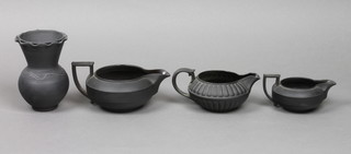 A Wedgwood black basalt jug 6", a fluted do. 5", a plain do. 4" and a similar vase 4" 