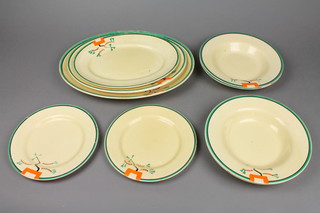 A 9 piece Clarice Cliff Bizarre pottery dinner service comprising 3 graduated meat plates 14", 12 1/2" and 11" and 4 soup bowls 9" (1 chipped), 2 side plates 8" (1 cracked, 1 chipped)