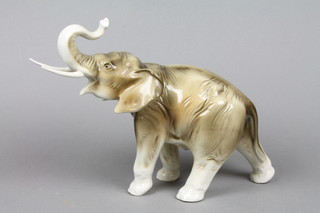 A Royal Dux figure of a walking elephant, the base with pink triangle mark 10"
