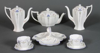 A Shelley Art Deco Blue Iris pattern tea and coffee service comprising 9 coffee cups, 12 saucers, 10 tea cups, 12 saucers, 2 cream jugs, teapot and cover, milk jug,sugar bowl, 2 coffee pots and covers, a serving bowl, 6 breakfast bowls, 2 sandwich plates, 12 side plates, 6 smaller plates, 6 biscuit plates and a 3 division hors d'oeuvres dish (2 coffee cups f, 1 tea cup f, 1 coffee pot lid f, sugar bowl f, hors d'eouvres dish f, 2 saucers f and 1 side plate f)
