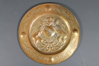 A circular Continental embossed brass charger 27" 