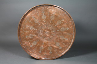 A circular Eastern copper charger 39" diam, together with a folding table stand